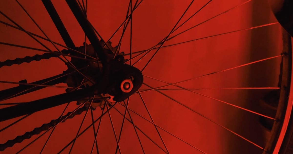 Bicycle wheel spokes against a red background